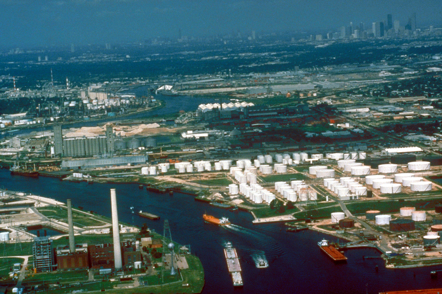 Aerial view of a small section of the Houston Ship Channel on Buffalo Bayou, which leads upstream directly into the city of Houston, Texas, USA. The downtown section of Houston can be seen at upper ri